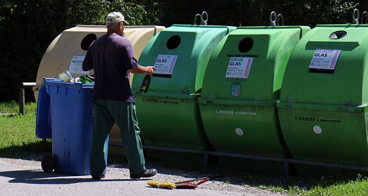 man recycling glass