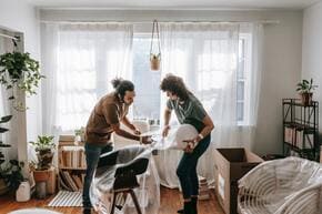 couple wrapping furniture